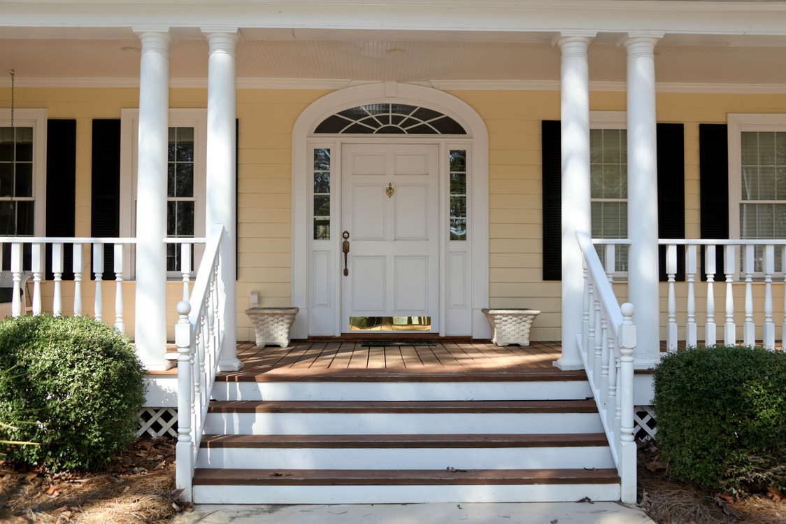 Front porch steps of house with columns, veranda